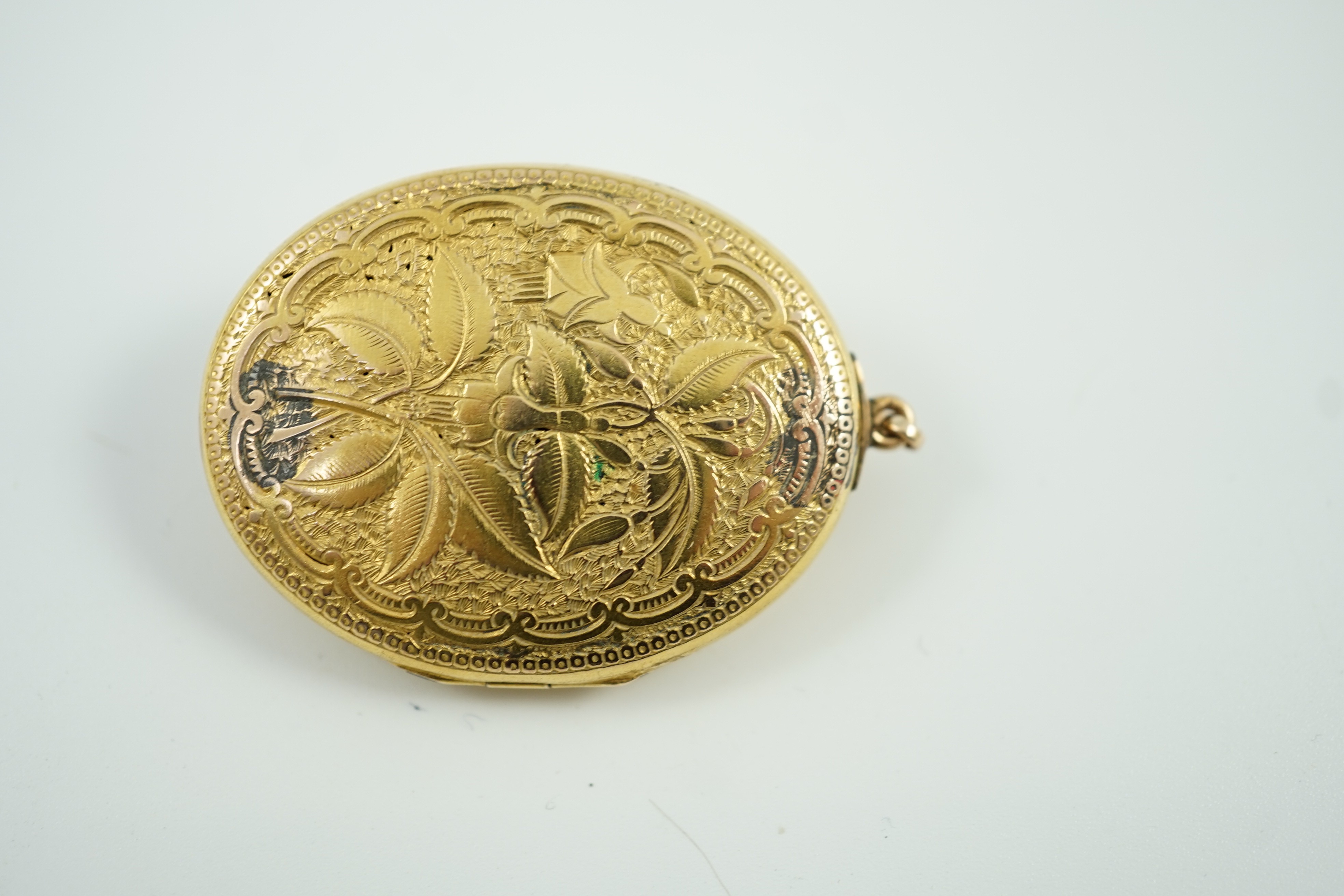 A Victorian yellow metal, blue enamel and seed pearl set oval locket, 40mm, gross weight 13.8 grams.
